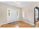 Bright and airy entryway with hardwood floors, a white front door with sidelights, and fresh paint at 9223 Silver Lake Dr, Leesburg, FL 34788