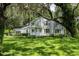 Beautiful two-story home with mature landscaping, lush green lawn, and large trees with Spanish moss at 9223 Silver Lake Dr, Leesburg, FL 34788