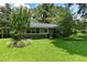 Charming single story house with lush landscaping and a green lawn at 9223 Silver Lake Dr, Leesburg, FL 34788