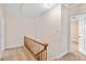 Hallway with carpet and wooden staircase leading to rooms and attic access at 9223 Silver Lake Dr, Leesburg, FL 34788