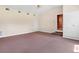 Spacious living room with carpet, large windows, and a neutral color scheme, enhancing the airy feel of the space at 9223 Silver Lake Dr, Leesburg, FL 34788