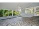 Covered patio with brick flooring, offering a view of the backyard at 9223 Silver Lake Dr, Leesburg, FL 34788