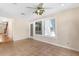 Bright sunroom with tile floors, ceiling fan, and expansive windows and doors that bring in natural light at 9223 Silver Lake Dr, Leesburg, FL 34788