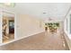 A spacious sunroom with tile flooring, neutral walls, ceiling fans, and large windows offering plenty of sunlight at 9223 Silver Lake Dr, Leesburg, FL 34788