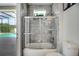 Stylish bathroom featuring a tiled shower and tub, and access to the pool area at 9702 Pepper Tree Pl, Wildwood, FL 34785