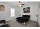 Inviting bedroom with a ceiling fan, a window and neutral carpeting at 9702 Pepper Tree Pl, Wildwood, FL 34785