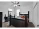 Inviting bedroom featuring modern furniture, ceiling fan, and a window bringing in natural light at 9702 Pepper Tree Pl, Wildwood, FL 34785