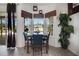Cozy breakfast nook with large windows providing lots of natural light, a table, and wood floors at 9702 Pepper Tree Pl, Wildwood, FL 34785