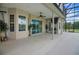 Spacious covered patio with ceiling fan, offering a perfect spot for outdoor dining or relaxing at 9702 Pepper Tree Pl, Wildwood, FL 34785