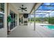 Covered patio area with a ceiling fan, bar-b-q grill, and screened enclosure, ideal for outdoor living at 9702 Pepper Tree Pl, Wildwood, FL 34785
