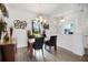 Elegant dining room with stylish lighting, neutral paint, and wood-style floors at 9702 Pepper Tree Pl, Wildwood, FL 34785