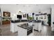 Spacious kitchen with large island, stainless steel appliances, granite countertops, and wood flooring at 9702 Pepper Tree Pl, Wildwood, FL 34785