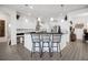 Bright open kitchen featuring a center island, stainless steel appliances, pendant lighting and bar seating at 9702 Pepper Tree Pl, Wildwood, FL 34785