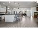 Bright open kitchen featuring white cabinetry, bar seating, and modern appliances at 9702 Pepper Tree Pl, Wildwood, FL 34785