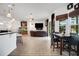 Open-concept living room with modern lighting, wood floors, and seamless flow to dining area at 9702 Pepper Tree Pl, Wildwood, FL 34785