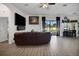Open-concept living room with tile floors, stylish decor, and sliding doors leading to the patio at 9702 Pepper Tree Pl, Wildwood, FL 34785