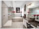 Modern main bathroom with a glass-enclosed shower, soaking tub, and double sink vanity at 9702 Pepper Tree Pl, Wildwood, FL 34785