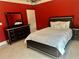 Bedroom featuring tile flooring, a decorative dresser, a mirror, and dark furniture with crystal accents at 10301 Savannah Ridge Ln, Winter Garden, FL 34787