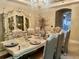Formal dining room features a set dining table, decorative cabinet, and crystal chandelier at 10301 Savannah Ridge Ln, Winter Garden, FL 34787