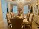 Formal dining room features a set dining table, decorative cabinet, and crystal chandelier at 10301 Savannah Ridge Ln, Winter Garden, FL 34787