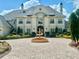 Beautifully landscaped home exterior featuring a grand circular driveway and striking water fountain at 10301 Savannah Ridge Ln, Winter Garden, FL 34787