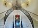 Grand foyer featuring a curved staircase, crystal chandelier, and decorative accents at 10301 Savannah Ridge Ln, Winter Garden, FL 34787