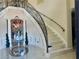 Stately curved staircase with marble steps and wrought iron railing, enhanced by an ornate foyer at 10301 Savannah Ridge Ln, Winter Garden, FL 34787