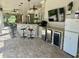 Covered outdoor bar area with seating, ceiling fans, lighting, appliances, and a TV at 10301 Savannah Ridge Ln, Winter Garden, FL 34787