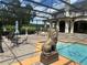 Backyard pool with lion statue, outdoor seating, and views of the beautiful property at 10301 Savannah Ridge Ln, Winter Garden, FL 34787