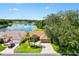 Beautiful aerial shot showcasing a home by a lake with mature trees and well-kept lawns at 1032 Ventura Dr, Lady Lake, FL 32159