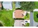 Aerial view of the property featuring a well-maintained roof, landscaping and a convenient driveway at 1032 Ventura Dr, Lady Lake, FL 32159