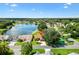 Neighborhood aerial view with pond and manicured lawns, showcasing peaceful community setting at 1032 Ventura Dr, Lady Lake, FL 32159