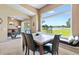 Dining area with large window offering views of the backyard and a tranquil lake at 1032 Ventura Dr, Lady Lake, FL 32159