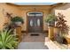 Welcoming front entrance with double doors, decorative plants, and brick-paved walkway at 1032 Ventura Dr, Lady Lake, FL 32159