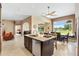 Open kitchen with granite countertops, a central island, and a dining area with lake views at 1032 Ventura Dr, Lady Lake, FL 32159