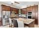 Gourmet kitchen featuring granite countertops, custom cabinetry, stainless steel appliances and a large island at 1032 Ventura Dr, Lady Lake, FL 32159
