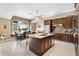 Modern kitchen with a granite island, stainless steel appliances, and a cozy breakfast nook at 1032 Ventura Dr, Lady Lake, FL 32159