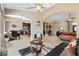 Open-concept living room flows into dining and kitchen, showcasing tile flooring and neutral color scheme at 1032 Ventura Dr, Lady Lake, FL 32159
