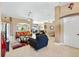 Open-concept living room with neutral tones, recessed lighting, and seamless flow to dining and kitchen at 1032 Ventura Dr, Lady Lake, FL 32159