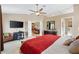 Comfortable main bedroom with tv, desk and chair for a flexible living space at 1032 Ventura Dr, Lady Lake, FL 32159