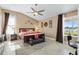 Spacious main bedroom features a ceiling fan, ensuite bath and views of the adjacent lake at 1032 Ventura Dr, Lady Lake, FL 32159