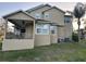 Back exterior view of home featuring a covered porch and grassy area at 1096 Linkside Ct, Apopka, FL 32712