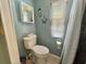 Toilet in bathroom with nautical decor and shower at 113 Temple W Cv, Leesburg, FL 34748