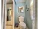 Toilet and shower area in bathroom featuring nautical decor at 113 Temple W Cv, Leesburg, FL 34748