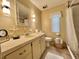 Functional bathroom featuring a vanity, tiled countertop, decorative accents, and a walk-in shower, providing essential amenities at 113 Temple W Cv, Leesburg, FL 34748