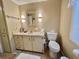Efficient bathroom featuring a vanity with storage, tiled floor, and essential fixtures, offering a practical and clean space at 113 Temple W Cv, Leesburg, FL 34748