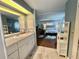 Bathroom area with vanity, shelving, and view into the primary bedroom at 113 Temple W Cv, Leesburg, FL 34748