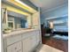 Bathroom vanity leading into the primary bedroom at 113 Temple W Cv, Leesburg, FL 34748