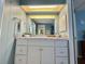Bright bathroom showcasing white vanity with decorative knobs and ample lighting at 113 Temple W Cv, Leesburg, FL 34748
