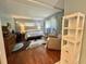 Primary bedroom features a king bed, desk, and dresser with a wood floor at 113 Temple W Cv, Leesburg, FL 34748